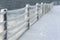 Fence on walkway covered in snow