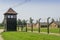 Fence and watchtower surrounding residential buildings in Auschwitz-Birkenau concentration camp, Poland