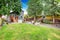 Fenced back yard with patio area and white adirondack chairs.