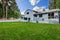 Fenced backyard garden with green grass.