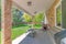 Fenced backyard of a house with sliding glass back door and large green lawn