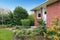 Fenced backyard. View of lawn and flower beds