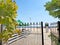 Fenced beach entrance to the sea and sun loungers on the sand