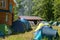 Fenced, guarded camping base with tents. Near the house and forest