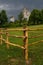 Fenced meadow and castle ruins