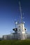 Fenced off signal house with tall antenna mast for shipping navigation on Mount Victoria, Devonport, Auckland, New Zealand