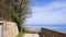 A fenced park with trees and a lamppost overlooking the Mediterranean Sea Marche, Italy