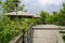 Fenced and planked platform with canopies for sightseer in trees