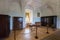 Fenced room with table, chairs and several chests of drawers, showing the life of the Middle Ages