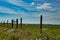 Fenceline along a hay field as an agricultural background