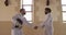 Fencer athletes during a fencing training in a gym