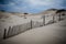 Fencing along the sand dunes at Cape Cod National Seashore on an overcast day