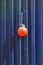 Fencing of construction site with red construction light on the background of blue profiled sheet fence