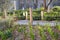 fencing the flowerbed with wooden square posts with ropes separates the pavement from the flower bed