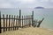 Fencing space. Skewed. Sea beach and island. Rainy day in September.