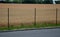Fencing with a wire fence 2 m high cereal field concrete interlocking paving