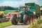 Fendt Favorit 926 Vario tractor drives with a Krone ZX400GL trailer on a dirt road