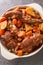 Fenkata is the national dish of Malta, a communal meal that is prepared with rabbit as the star of the feast closeup in the pan.