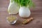 Fennel bulb and seeds in a scoop and bowl on wooden background