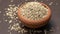 Fennel seeds in a small clay bowl on an old wooden table./ Fennel seeds over white background.