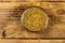 Fenugreek seeds in glass bowl on wooden table