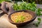 Fenugreek seeds on a wooden spoon on a table