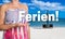 Ferien (in german Holiday) concept is presented by woman on the