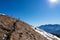 Ferlacher Horn - Woman on panoramic hiking trail on way to snow covered mountain peak Ferlacher Horn