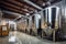 Fermentation mash vats or boiler tanks in a brewery factory. Brewery plant interior. Factory for the production of beer. Modern