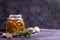 Fermented canned champignon mushrooms in a glass jar with garlic, bay leaf and a white napkin with dill