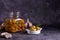 Fermented canned champignon mushrooms in a white plate for appetizers and in a glass jar with garlic, bay leaf and a white napkin