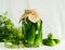 Fermented or canning cucumbers in glass jar on table a light background. Processing of the autumn harvest. Canned food