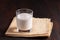 Fermented drink kefir in a glass glass on bworn wooden background