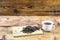 Fermented Ivan-tea on wooden board. Dry herbal natural tea. White cup with Ivan-tea. Side view.