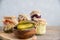 Fermented, pickled, pickled cucumbers closeup in a wooden round bowl. In the background vegetable preparations for the winter in