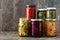 Fermented preserved vegetables in jar isolated on wood