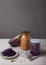 Fermented red and white cabbage in jars, a head of red cabbage and a plate with salad stand on a wooden table on a gray background