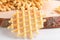 Ferratelle or pizzelle a traditional dessert or cookies from Abruzzo on a cutting board on a white wooden background