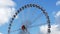 Ferris wheel against blue sky 4k footage real time