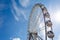 Ferris wheel against the blue sky and clouds on a sunny day - Saint Petersburg, Russia 2021