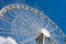 Ferris wheel against the blue sky and clouds on a sunny day - Saint Petersburg, Russia 2021