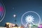 Ferris wheel at amusement park moving at night doing lightpainting