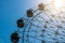 Ferris wheel with blue sky and sunset.