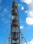 Ferris Wheel Cabins, Blue Sky and White Clouds