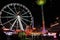 Ferris wheel at the celebration in the amusement park in the square in the city