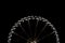 A ferris wheel cropped in half at night time