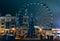 Ferris wheel in dark evening Kyiv on background