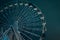 Ferris wheel in dark evening Kyiv on background