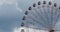 Ferris wheel on fun fair on blue sky white clouds background, timelapse video.