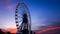 Ferris wheel in motion at sunset time